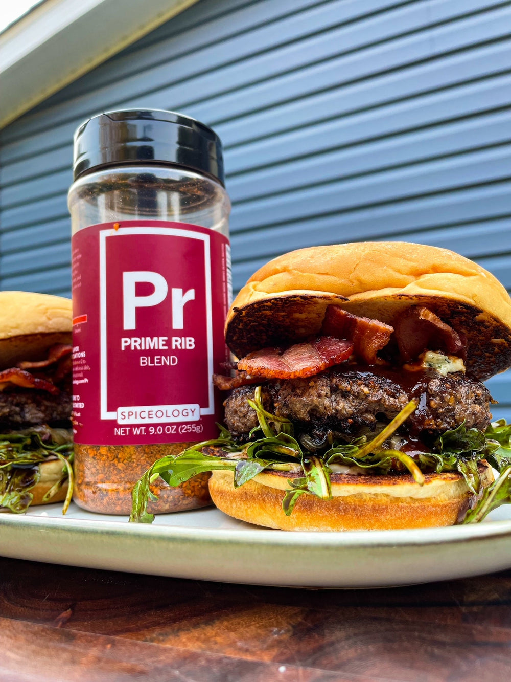 Spiceology Prime Rib Costco jar next to a stacked bacon burger