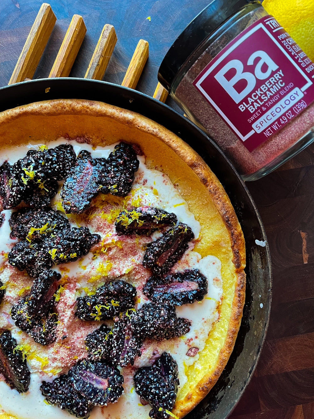 Dutch Baby pancake topped with fresh lemon marscapone and blackberries and Spiceology Blackberry Balsamic jar