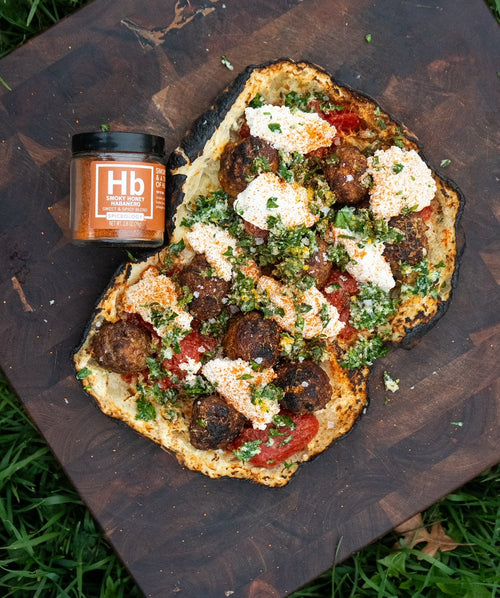 A meatball flatbread fresh off the grill using Spiceology Smoky Honey Habanero blend