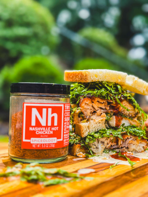 Stacked Nashville Hot Deep Fried Red Snapper Sandwich with a jar of Spiceology Nashville Hot blend