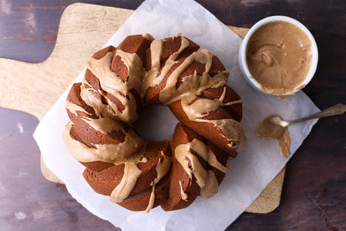 Pumpkin Spice Sherry Bundt Cake with bowl of Pumpkin Maple Icing 