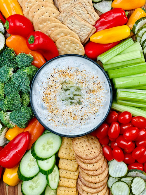 Bowl of Buffalo Lemon Pepper Dip surrounded by veggies for dipping