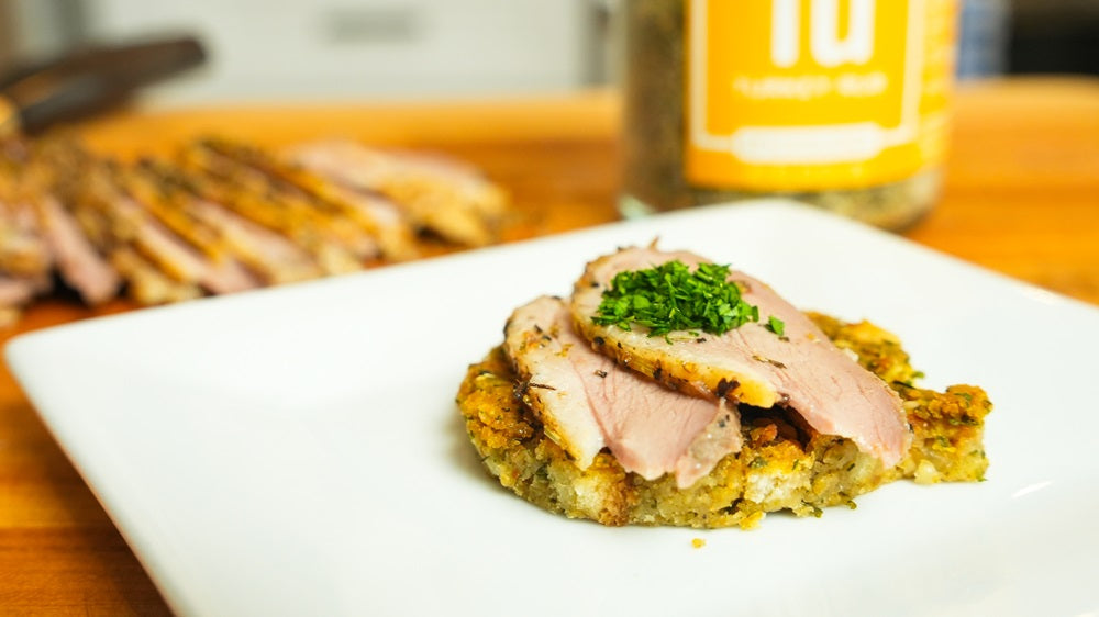 Plated Turkey Rub Duck Breast under a bed of stuffing with a jar of Spiceology Turkey Rub