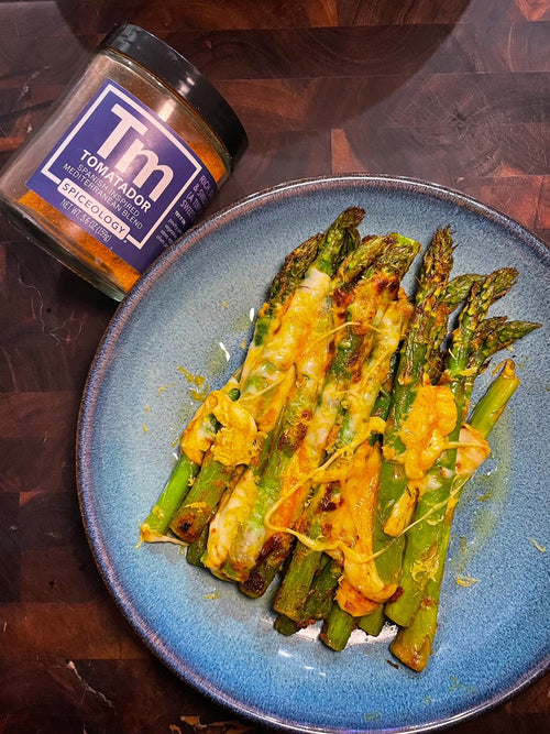 Plated Tomatador & Mozzarella Air Fried Asparagus next to a Spiceology Tomatador jar