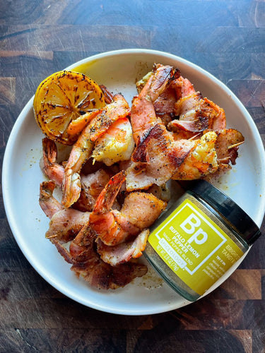 Plated Bacon-Wrapped Shrimp next to jar of Spiceology Buffalo Lemon Pepper