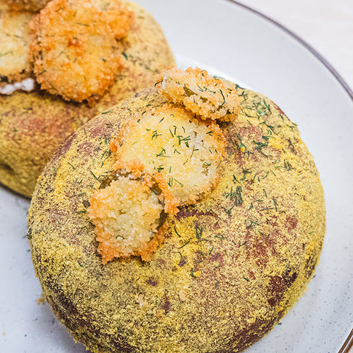 Picture of two Really Ranch Salmon Cream Filled Donuts with pickle chips on top