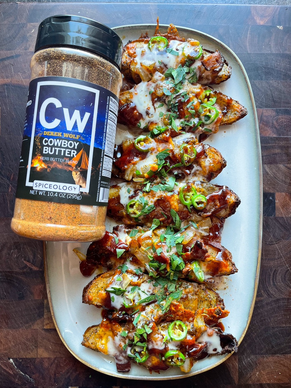 Plated Loaded Potato Skins next to Spiceology Cowboy Butter jar