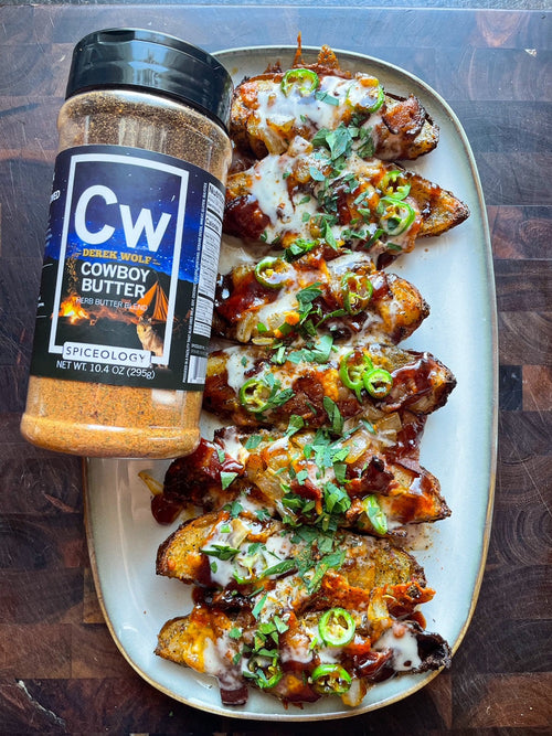 Plated Loaded Potato Skins next to Spiceology Cowboy Butter jar