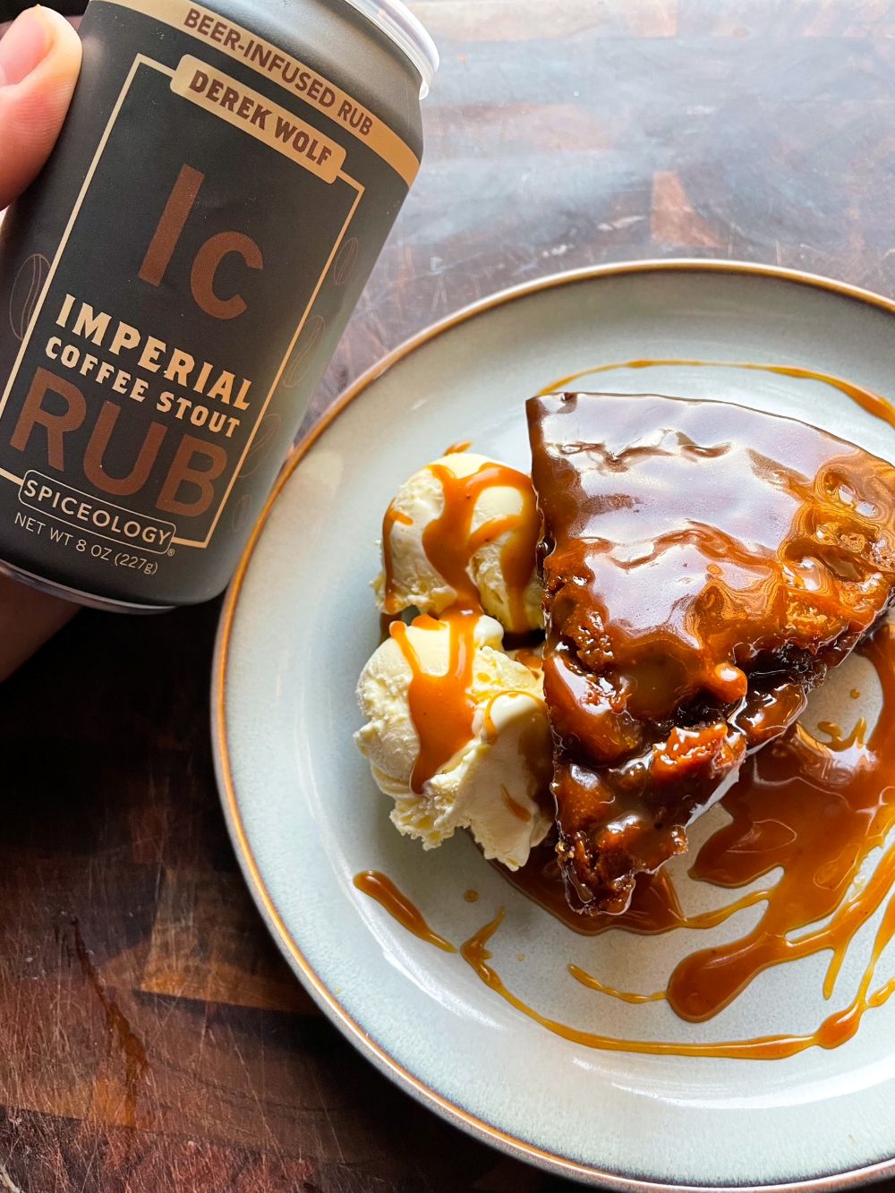 Plated slice of Sticky Toffee Pudding next to a can of Spiceology  Imperial Coffee Stout rub