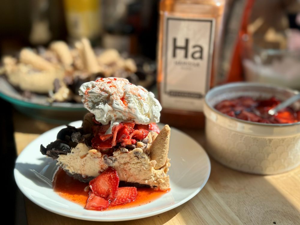 Plated slice of  Peanut Butter Ice Box Pie with Spiceology Harissa jar in the background
