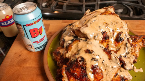 Finished Beer-inade Grilled Chicken next to a can of Spiceology X King of the Hill Beer-Infused BBQ Rub