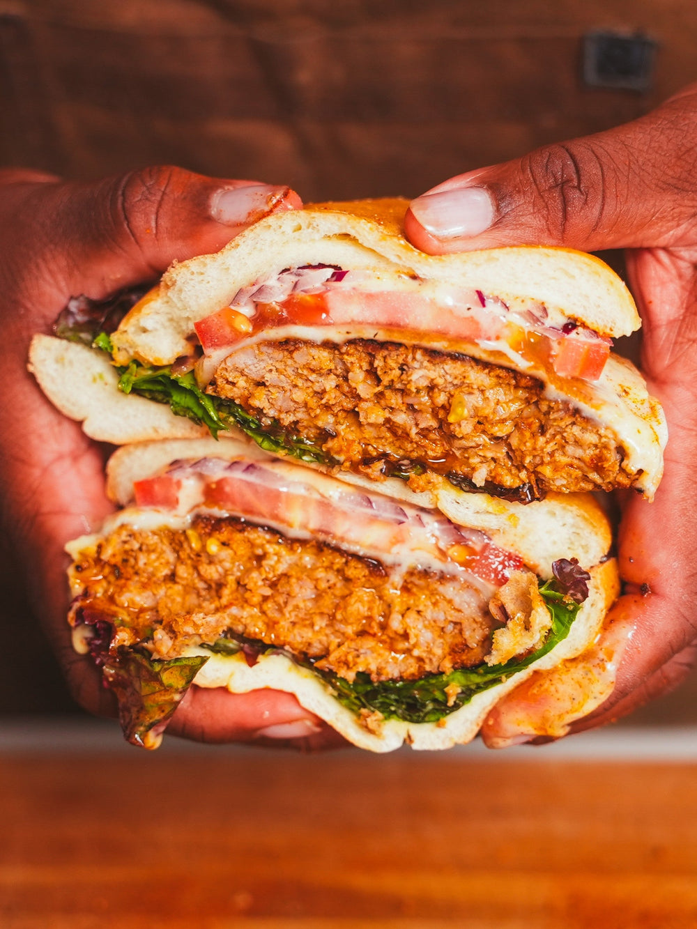 Stacked cross section of cut Black Magic Pork & Greens Burger 