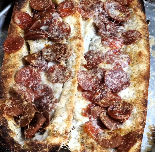 Sliced Pepperoni & Cheese Garlic Bread with a jar of Spiceology Walmart Double Garlic blend