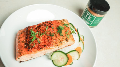 Plated salmon filet over rice next to a jar of Spiceology Teriyaki Takeout
