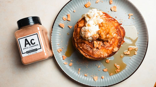 Plated Cinnamon Toast Crunch Cereal Milk Pancakes & Apple Compote next to a jar of Spiceology Apple Cinnamon blend