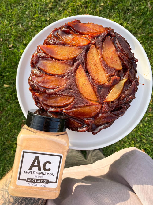 Plated Caramel Apple Cinnamon Upside Down Cake next to a jar of Spiceology Apple Cinnamon jar