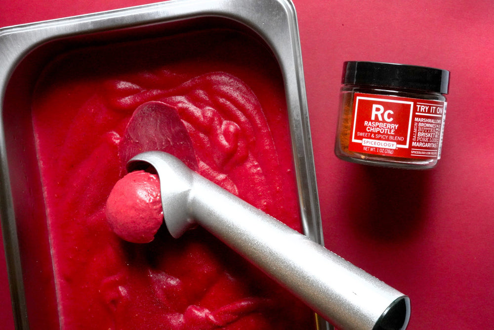 raspberry chipotle sorbet in metal container with ice cream scooper