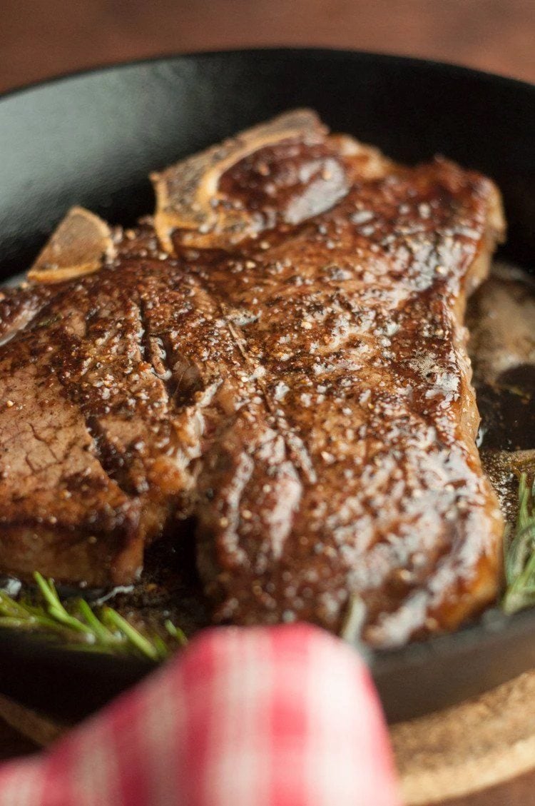 Pan Seared Steak With Smoky Honey Habanero Butter in a cast iron pan