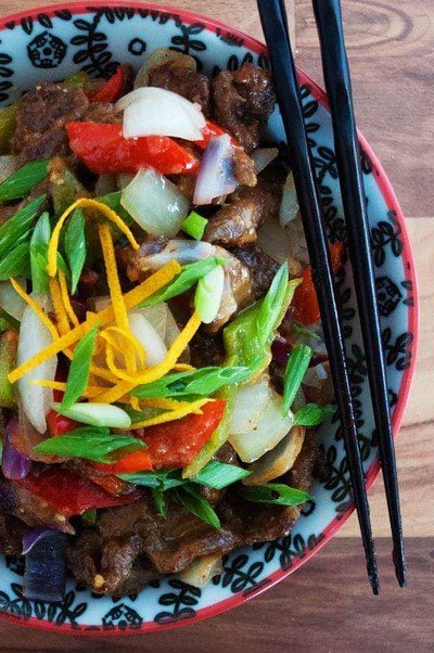 Spicy orange beef with fresh veggies in a bowl