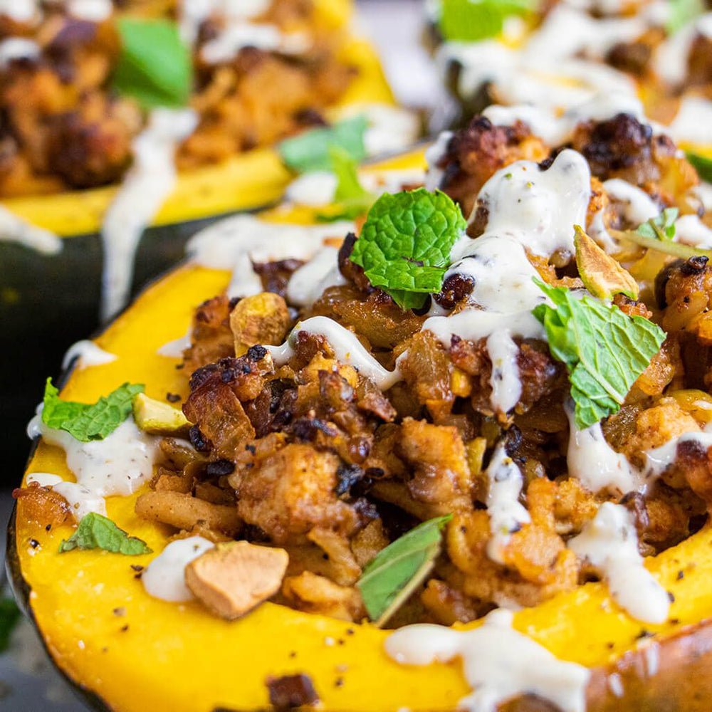 tandoori glory stuffed acorn squash topped with fresh mint leaves