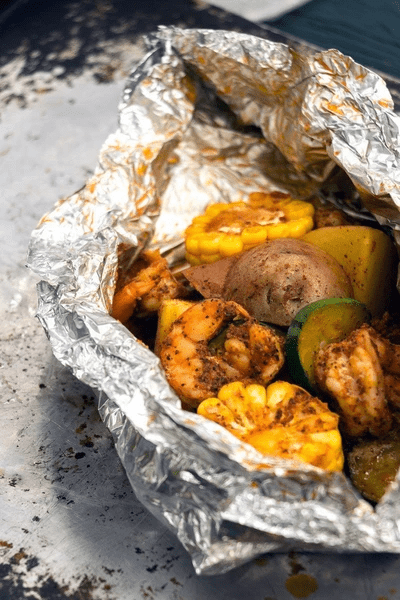 Tinfoil shrimp bowl with shrimp, corn, potatoes and veggies