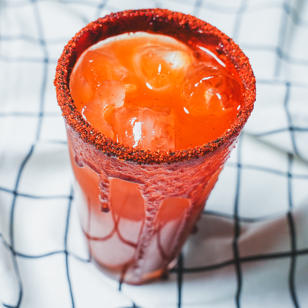 Red cup holding a frozen red or orange drink or dessert