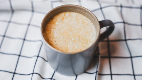Mug of coffee on a checkered fabric background
