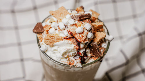 S'mores Milkshake featuring A classic hand-spun milkshake made with vanilla ice cream, finished with Spiceology's S’mores seasoning for toasted cocoa richness, graham-cracker sweetness, and a hint of campfire warmth in a glass.