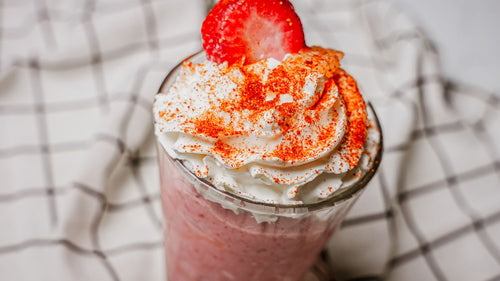 Mango Chile Strawberry Lemon Twist featuring a vibrant blend of strawberry and lemonade brightened with Spiceology's Mango Tango chamoy-style seasoning, adding tropical mango sweetness and a subtle chile warmth that builds at the finish served in a glass.