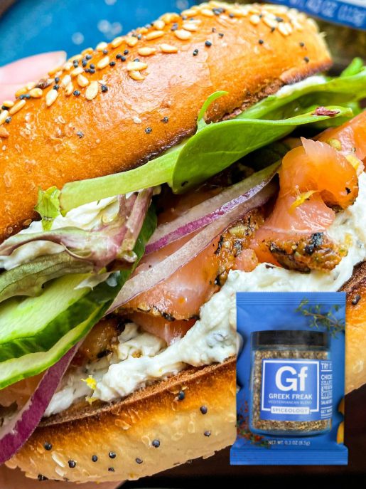 Greek Freak cream cheese spread with feta, olives, and Mediterranean herbs in a white serving bowl, ready to serve