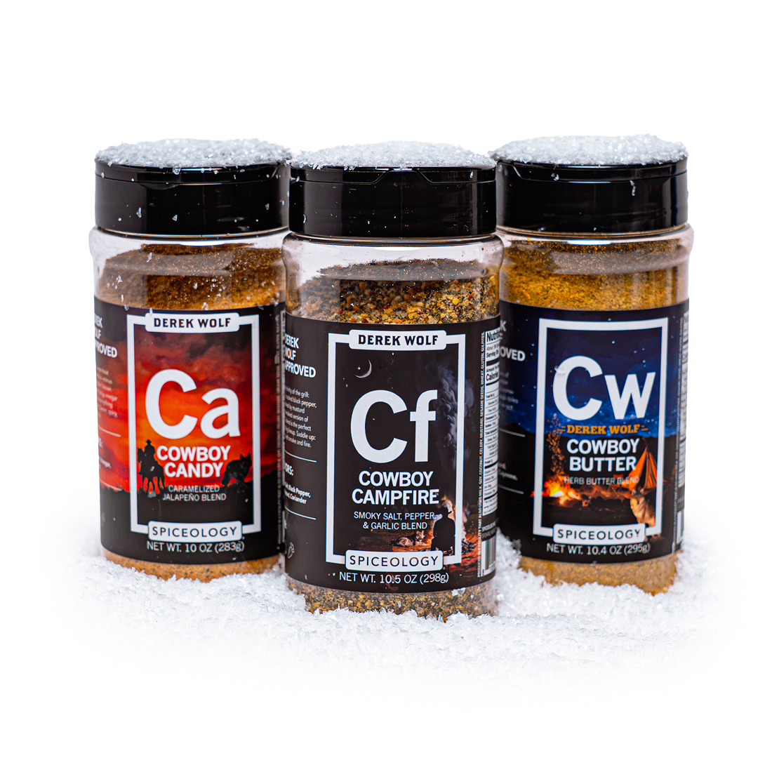 A popcorn seasoning six-pack in an open gift box, surrounded by glass holiday ornaments