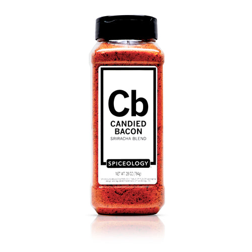 A clear plastic bottle with a black lid containing Curry Madras spice blend. The label displays nutrition facts and ingredients on the back of the bottle. The spice inside is a fine, yellow-brown powder.