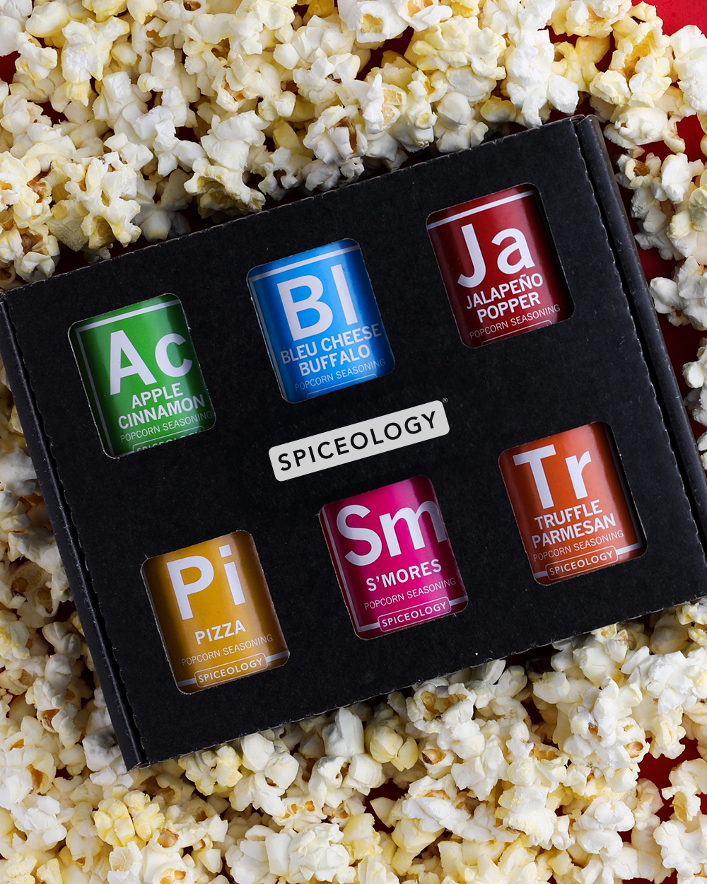 Popcorn Seasoning Variety Pack in a pile of popcorn