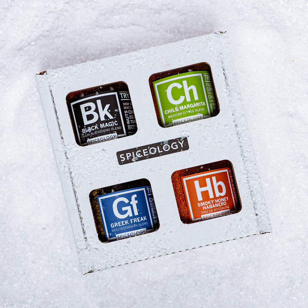 A popcorn seasoning six-pack gift box half-buried in snow