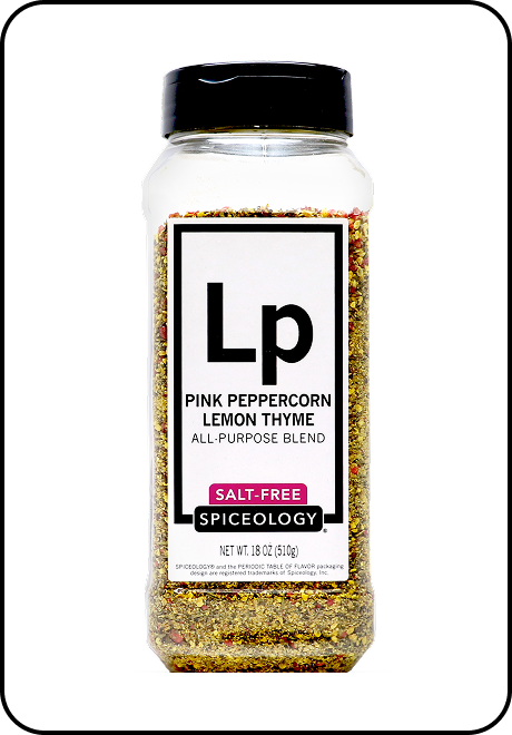 Spice jar labeled Spiceology pink peppercorn lemon thyme salt-free blend on a white background
