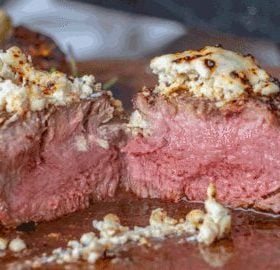 Steak with Gorgonzola cheese crusted on top