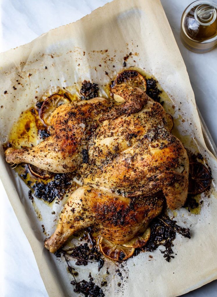 Greek freak oven roasted spatchcock chicken on a sheet pan