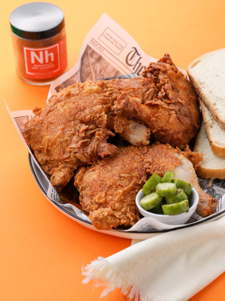 fried chicken on a plate with an orange background