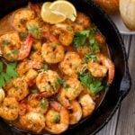 a skillet with cooked prawns
