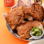 Nashville hot chicken on plate with pickles