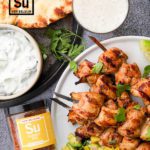 Summer BBQ chicken skewers on plate with dipping sauce