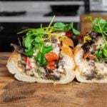 Mushroom Philly sandwich sliced in half