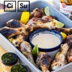 New Belgium Brewing grilled chicken drumsticks in serving pan with dipping sauce