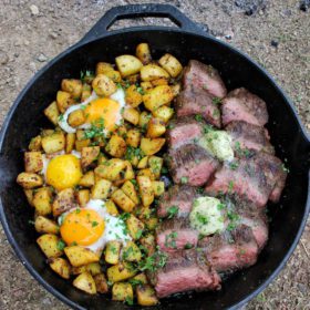 bourbon prime steak and eggs in a cast iron pan