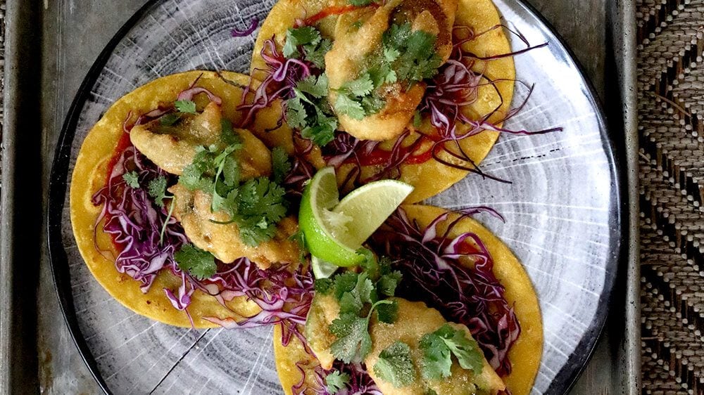 New Belgium sweet and sour avocado baja tacos on plate