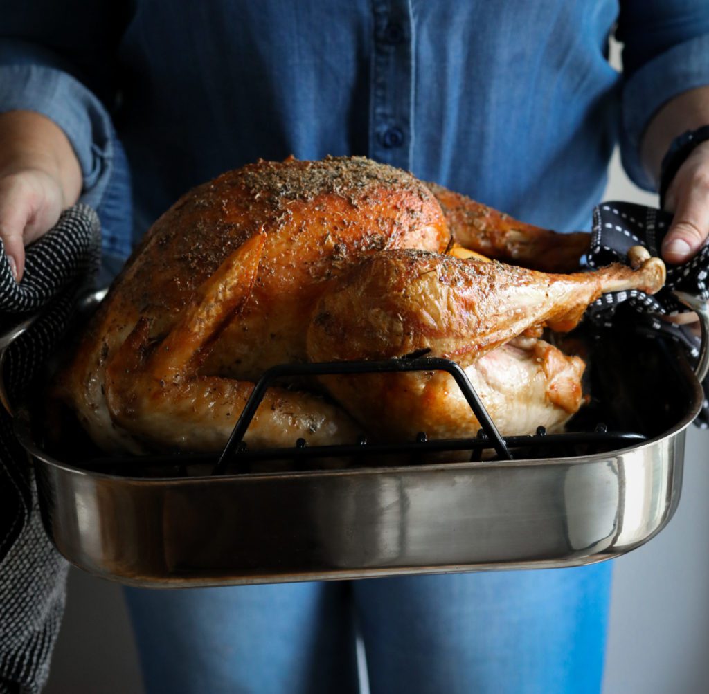 a roasting pan with a cooked turkey