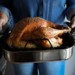 a roasting pan with a cooked turkey