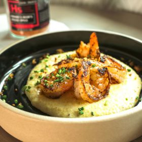 kwame shrimp and grits on black plate
