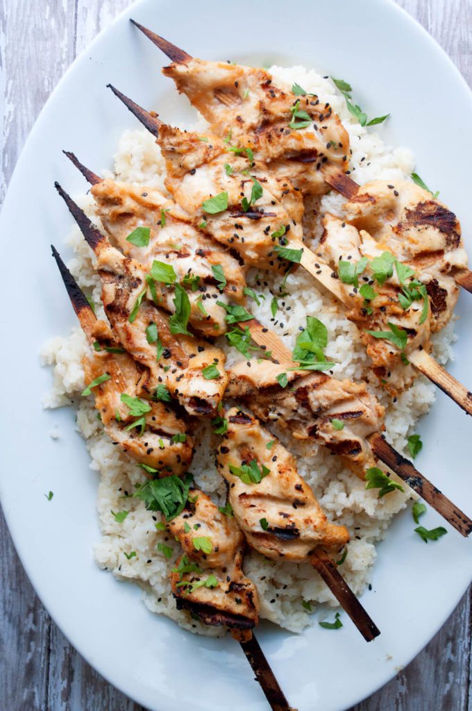 maui wowee chicken skewers on bed of rice on white plate